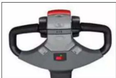 Top-down view of a gray manual pallet jack with black handle and red control knob (no text or symbols visible)