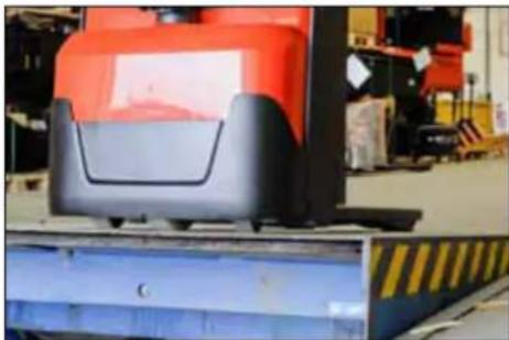 Industrial forklift handling a blue pallet, with no visible text or symbols