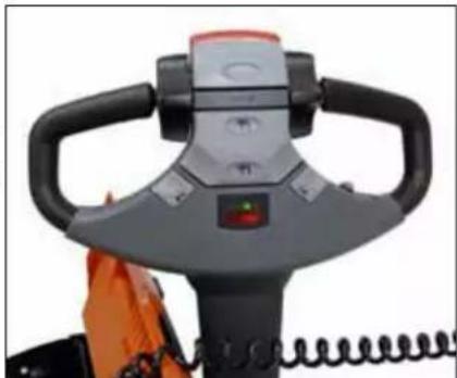 Close-up of a mechanical device with black handle and orange base, no visible text or symbols