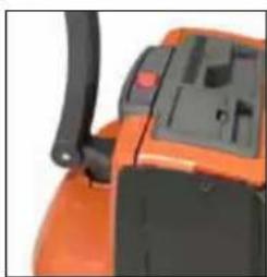 Close-up of an orange agricultural machine with black handle and control panel (no visible text or symbols)