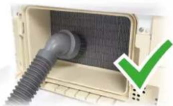 Interior view of a portable electronic device with a coiled tube and ventilation grille (no visible text or symbols)
