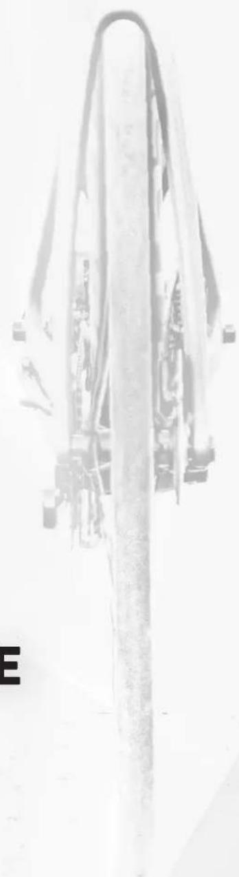 Black-and-white photo of a long, curved structure with attached components, possibly a mechanical or architectural component (no visible text or symbols)