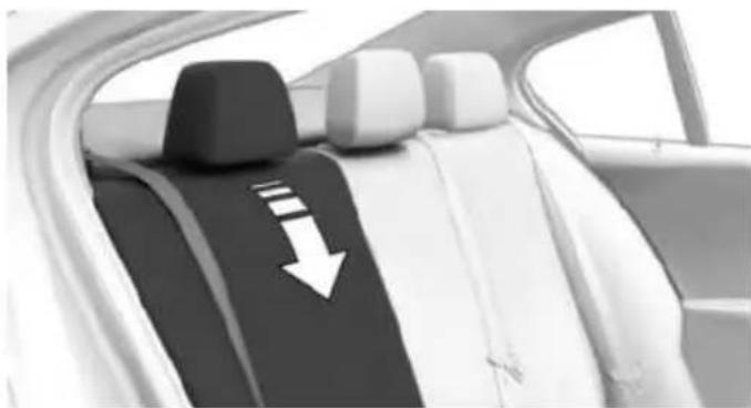 Interior view of a car backseat showing seat covers and a white arrow pointing to the lower side (no text or symbols visible)