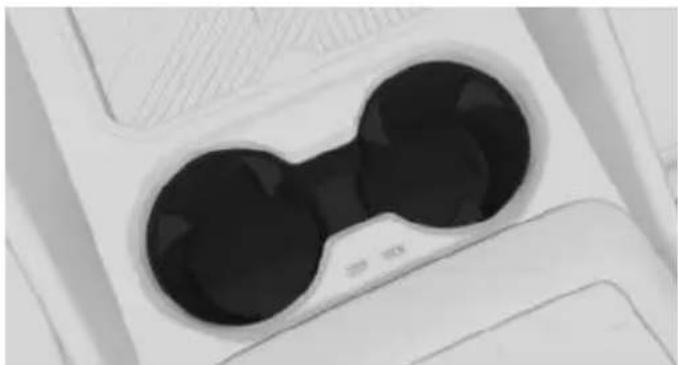 Close-up of a white electronic device with two black circular lenses (no visible text or symbols)