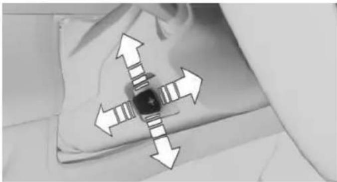 Black-and-white photo of a medical or surgical device with directional arrows indicating movement or force (no text or symbols visible)