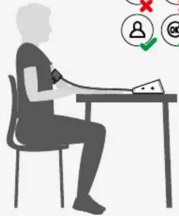 Silhouette of a person sitting at a desk using a pressure monitor, with checkmarks and a red X mark indicating status or error (no text or symbols present)