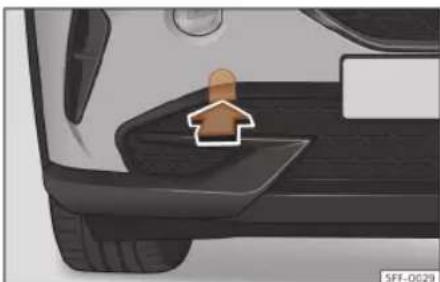 Close-up of a car's side profile showing a wooden handle and seat area (no text or symbols visible)