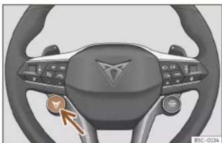 Interior view of a car dashboard with steering wheel and control buttons (no visible text or symbols)