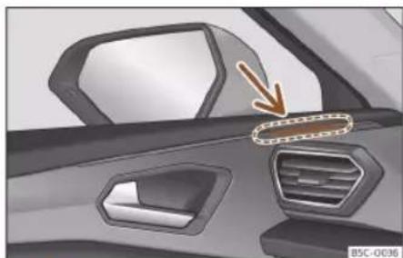 Interior view of a car showing the dashboard and air vent with a decorative arrow pointing to the side panel (no text or symbols visible)