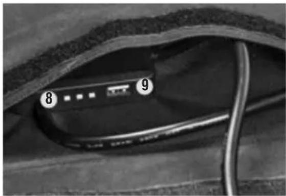 Close-up of a black electronic device with labeled parts (8 and 9), no readable text or symbols beyond labels