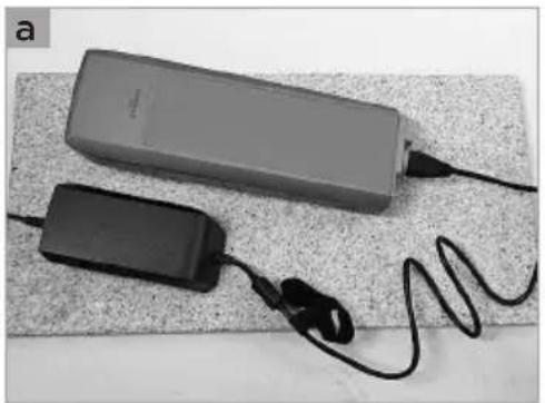 Two electronic devices with cables and earphones, placed on a textured surface (no visible text or symbols)