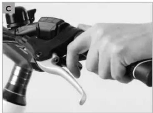 Close-up of a hand gripping a bicycle brake lever (no text or symbols visible)