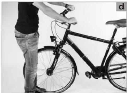 Person standing beside a bicycle with visible frame and seat, no text or symbols present