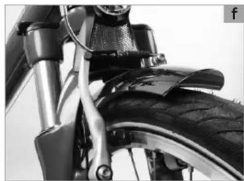 Close-up of a bicycle tire mounted on a metal frame, showing mechanical components and no visible text or symbols.