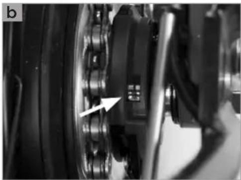 Close-up of mechanical components with a white arrow pointing to a specific component (no visible text or symbols)
