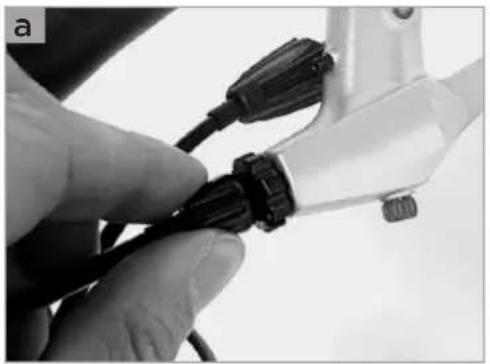 Close-up of a hand holding a black cable with connectors, no visible text or symbols