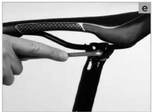 Close-up of a hand adjusting a bicycle wheel handle and lever mechanism (no text or symbols visible)