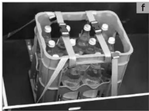 Black-and-white photo of a multi-wheeled battery pack with multiple bottles and connectors (no visible text or symbols)