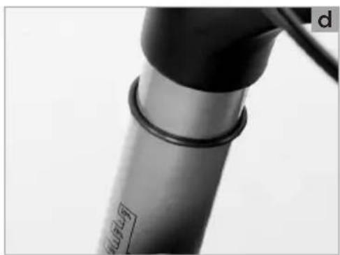 Close-up of a mechanical component with a cylindrical shaft and black end caps (no visible text or symbols)
