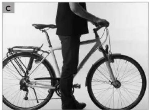 Person standing beside a bicycle, viewed from the side (no visible text or symbols)