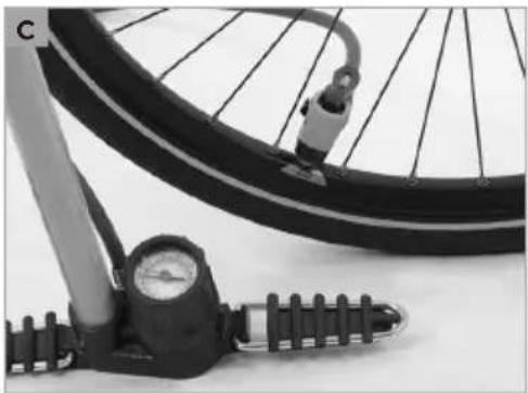 Close-up of a bicycle wheel with a pressure gauge and mechanical lever (no visible text or symbols)