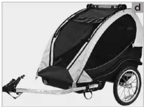 Black and white photo of a two-wheeled dog pod trailer with a metal frame and wheels (no text or symbols visible)