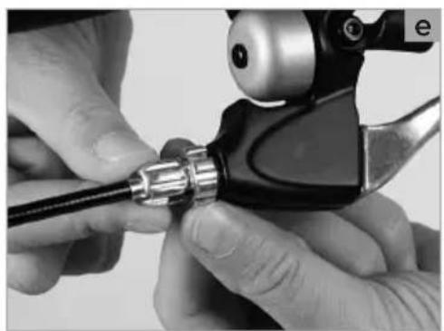 Close-up of hands using a tool to adjust a cable or connector (no visible text or symbols)
