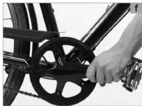 Close-up of a hand adjusting a bicycle wheel rim and chain, no visible text or symbols