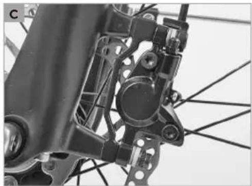 Close-up of bicycle frame components including brake calipers and suspension brackets (no text or symbols visible)
