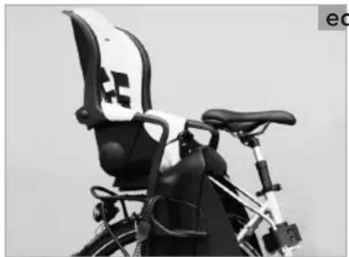 Black and white photo of a bicycle rear seat with a medical cross symbol on the backrest (no text or symbols visible)