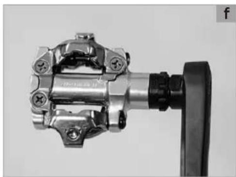 Close-up of a metallic mechanical component with mounting holes and a black handle (no visible text or symbols)