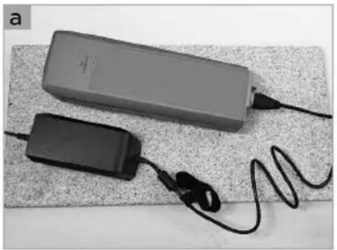 Two electronic devices with cables and earphones on a textured surface (no visible text or symbols)