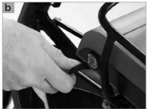 Close-up of a hand adjusting a mechanical component with a circular knob (no visible text or symbols)