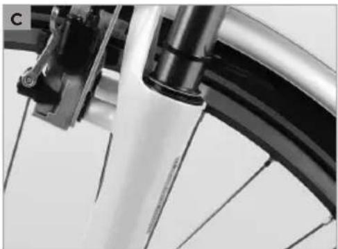 Close-up of a bicycle wheel rim and suspension bracket (no text or symbols visible)