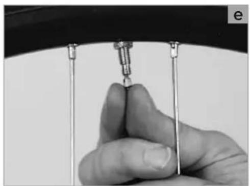 Close-up of a hand holding a small mechanical component, possibly a tool or sensor, with no visible text or symbols.