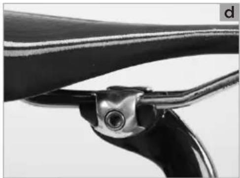 Close-up of a pair of metal tools or prongs with a central screw, no visible text or symbols