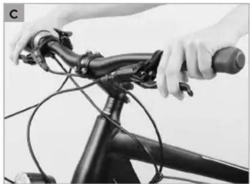 Close-up of hands adjusting a bicycle's head lever and cable (no text or symbols visible)