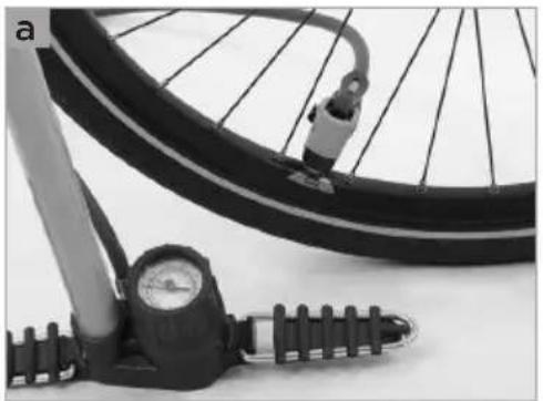 Close-up of a bicycle tire with a pressure gauge and handle, no visible text or symbols