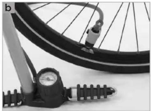 Close-up of a bicycle wheel with a pressure gauge and mechanical handle (no visible text or symbols)