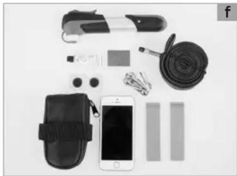 Assorted black-and-white photo of a wearable device set including armbag, cable, and smartphone (no text or symbols visible)