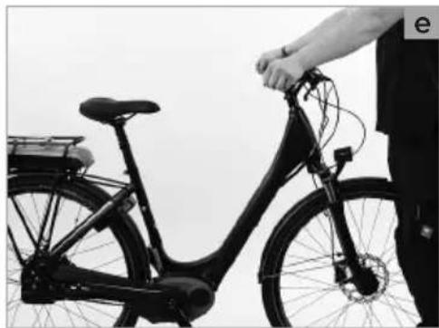 Black-and-white photo of a person adjusting a bicycle with a hand on top (no visible text or symbols)