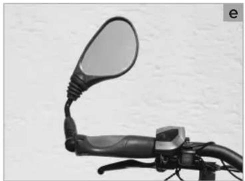 Close-up of a bicycle's front-mounted mirror and hand crank (no text or symbols visible)
