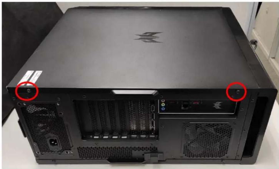 Back view of a black computer tower with visible drive bays and ventilation slots, marked with red circles (no text or symbols)