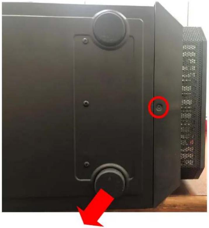 Close-up of a black industrial device with a red arrow pointing to a circular opening, no visible text or symbols.
