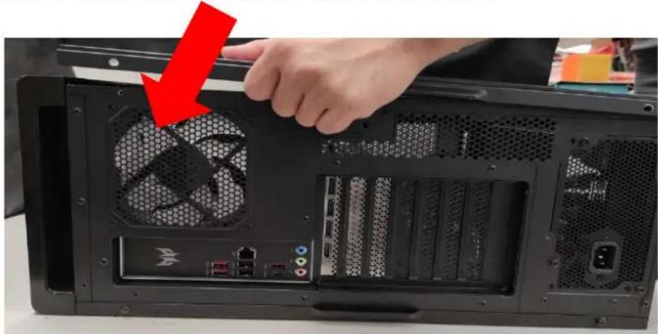 Back view of a computer tower internal gear fan with a hand adjusting the top panel (no text or symbols visible)