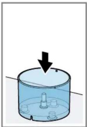 Diagram of a cylindrical container with a downward arrow indicating force or movement, no text or symbols present