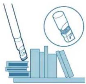 Illustration of a pen tip inserting into a stack of books, with an inset showing a rolled document (no text or symbols present).