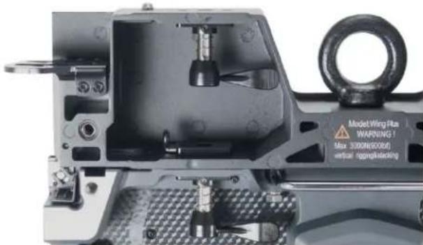 Close-up of a mechanical assembly with visible components and mounting holes (no readable text or symbols)