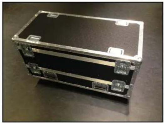 Exterior view of a black rectangular electronic device with metallic frame and mounting brackets (no visible text or symbols)