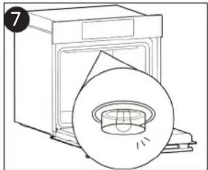 Line drawing of a washing machine with a circular disc and lid (no text or symbols)